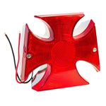 An image of a chrome die cast housing with wires on it, featuring a 12 Volt TC Bros. Maltese Cross Tail Light.