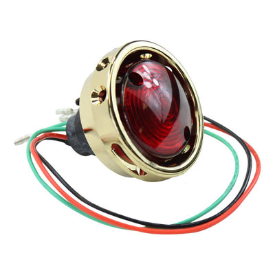 A red and green Mid-USA brass vintage drilled tail light on a white background.