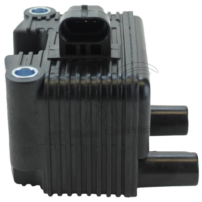 The Mid-USA .6Ω 12V Ignition Coil for 1999-2006 Harley-Davidson features cooling fins, two mounting holes, single-fire ignition support, two bottom cylindrical connectors, and a central wiring connector on top.