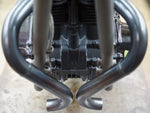 A close up of a motorcycle engine with Yamaha XS650 "Double D" Exhaust System by Pandemonium custom pipes and Pandemonium exhaust pipes.