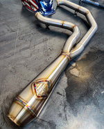 A SP Concepts motorcycle exhaust pipe with an American flag on it, enhancing the performance.
