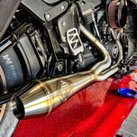 The SP Concepts Big Bore Exhaust M8 Softail 2018-Present - Stainless features polished stainless steel with visible welds and an engraved logo, designed for Monoshock Softail models, and is displayed on a gray work surface.