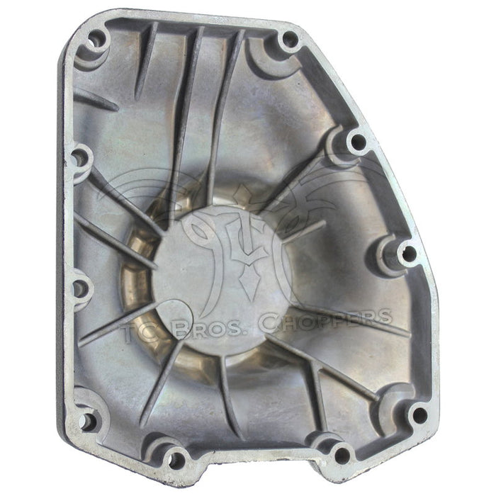 The Mid-USA Cam Cover for 2001-2017 Harley-Davidson Twin Cam features a black metal design with multiple bolt holes and a central raised circular section accented by a silver metallic component.