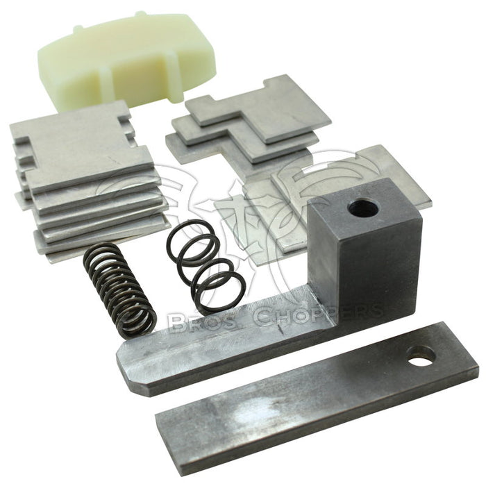 Hayden Enterprises Hayden M6 Self-Adjusting Primary Chain Tensioner for 1965-1993 Harley-Davidson Big Twin, featuring assorted metal and plastic parts including springs and plates, shown on a white background.