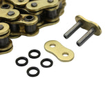 The TC Bros. 120 Link X-Ring 530 Heavy Duty Motorcycle Chain in gold, by TC Bros., is coiled neatly and includes two connecting links plus four O-rings, all shown on a white background.