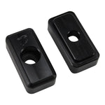 Two black rectangular metal blocks, TC Bros. Heavy Duty Billet Axle Adjusters for 1991-2005 Harley-Davidson Dyna, each with a central hole, are displayed on a white background. One block has the TC Bros. logo engraved on its surface.