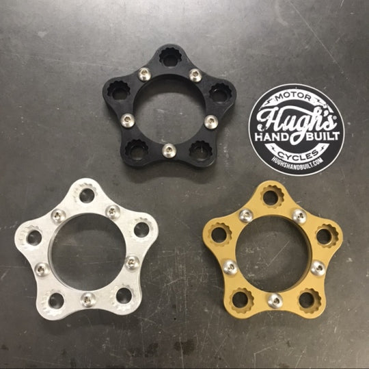 A rear sprocket with a bolt-on Hughs Handbuilt Harley Davidson Sprocket Lock System - Black on a motorcycle wheel.