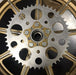 A close up of a HHB Harley Davidson Sprocket Lock System - Gold sprocket wheel by Hughs Handbuilt.
