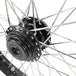 A close up of a black spoked Moto Iron® Harley FX and Sportster wheel with a Billet Hub on a white background.