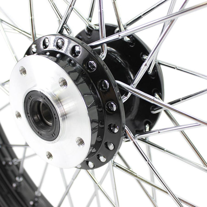 A close up of a Moto Iron® Black Front 40 Spoke Wheel 19" X 2.15" (fits Harley FX, Sportster 1984-1999) Billet Hub on a Harley FX and Sportster motorcycle.