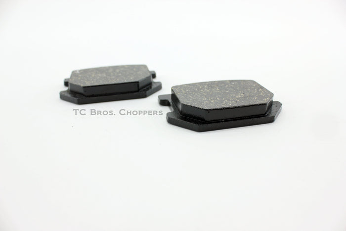 Two black Yamaha XS650 Brake Pads on a white surface.