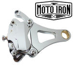 A Moto Iron® Left Side Springer Brake Caliper Kit in chrome, including bolts, washers, spacers, and a linkage rod, is displayed on a white background.
