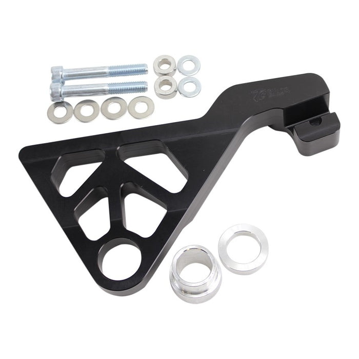 The TC Bros. 2008-2017 Harley Dyna Rear Radial Brake Bracket is a CNC-machined black metal bracket with geometric cutouts, ideal for brake conversion. It includes screws, washers, and spacers, displayed on a white background.