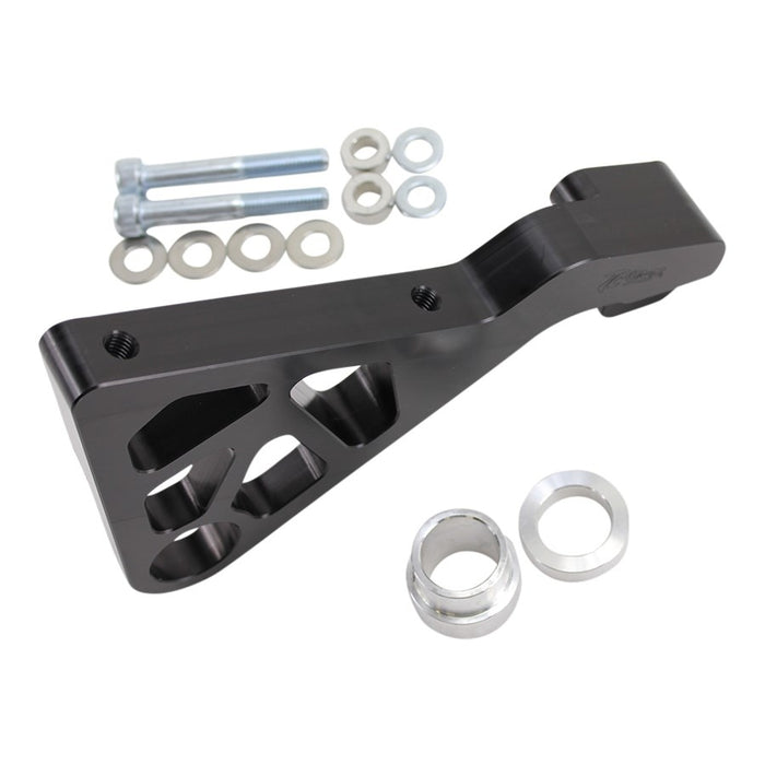 The TC Bros. 2008-2017 Harley Dyna Rear Radial Brake Bracket is a CNC-machined black metal bracket with geometric cutouts, ideal for brake conversion. It includes screws, washers, and spacers, displayed on a white background.