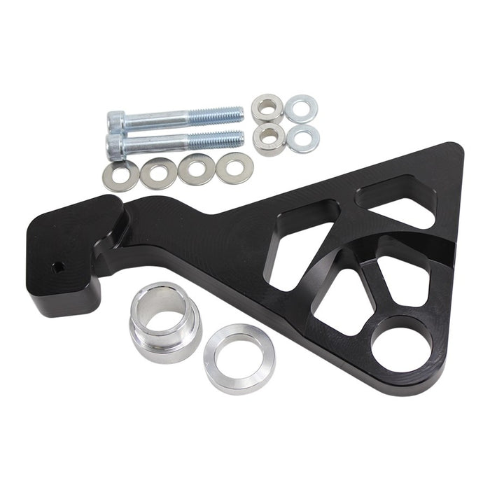 The TC Bros. 2008-2017 Harley Dyna Rear Radial Brake Bracket is a CNC-machined black metal bracket with geometric cutouts, ideal for brake conversion. It includes screws, washers, and spacers, displayed on a white background.