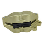 A Brembo P4 Axial Brake Caliper Left Side Gold 4 Piston for Harley applications on a white background.