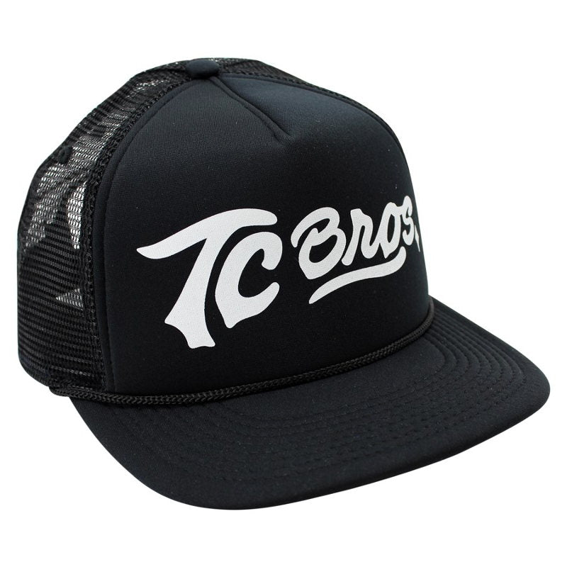 A TC Bros. Script Trucker Hat - Black/White with adjustable snapback closure, featuring TC Bros white lettering on it.