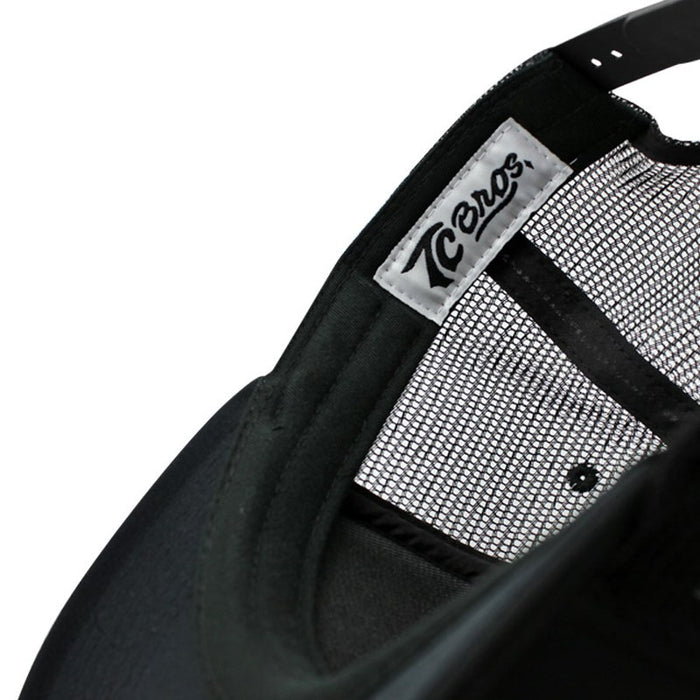 A close up image of a TC Bros. Diamond Trucker Hat - White/Black with an adjustable snapback closure and a black screen printed logo.