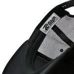A close-up image of a black TC Bros. Ol' Pete Trucker Hat by TC Bros.