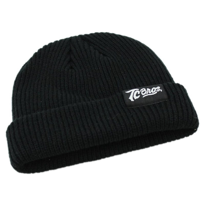 A soft acrylic TC Bros. Watchman Beanie - Black with a TC Bros. logo on it.