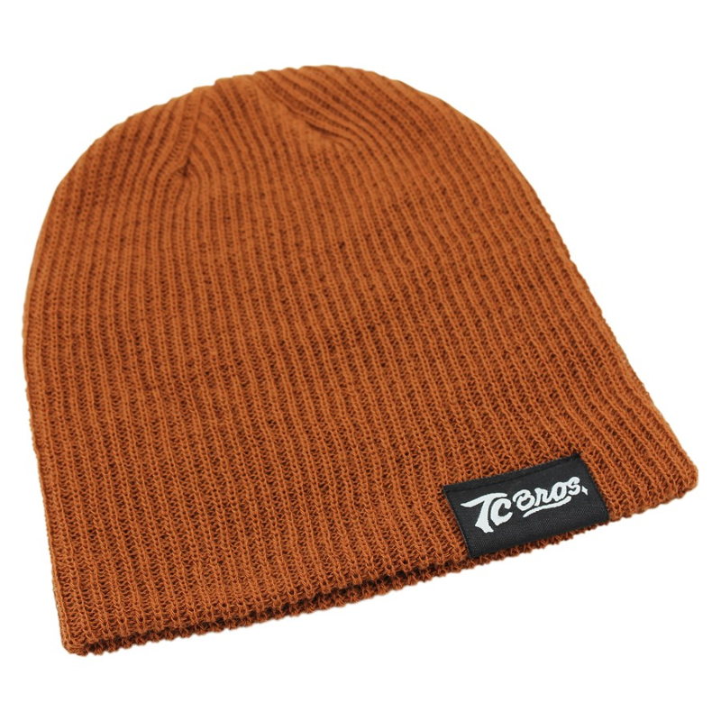 A brown TC Bros. Slouch Beanie with a Sewn On Clip Label.