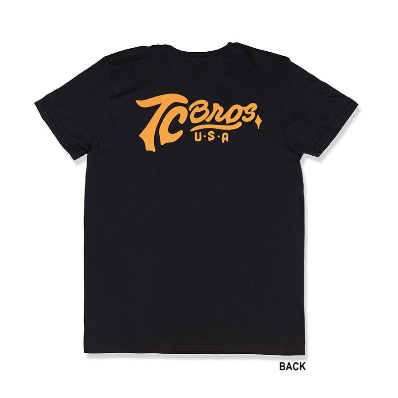 A TC Bros. Classic black T-shirt made of 100% ring-spun cotton with an orange logo on it.