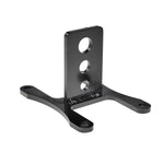 The Pangor Cycles Transmission Work Stand/Jig Mounting Bracket, a black metal bracket with four holes, is designed for supporting or attaching Harley-Davidson four-speed transmission components. Branded by Pangor Cycles and shown on a white background.