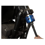 A person is using a Motion Pro Steering Bearing Race Install/Removal Tool to hold a blue hose on a Harley Davidson motorcycle.