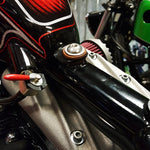 The TC Bros. Universal Frisco Gas Tank Mounting Kit includes two metal bolts, two metal washers, four tan washers, and two cylindrical tophat bungs spacers, all from TC Bros., displayed on a white background.