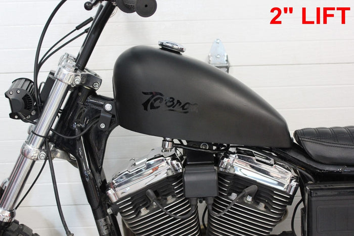 A pair of TC Bros. 1995-2003 Sportster 2" Gas Tank Lift Kit with nuts and bolts for a Sportster.