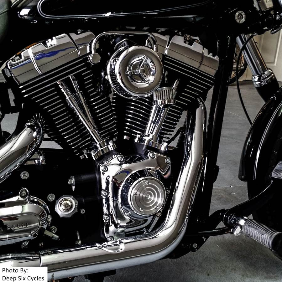 A disassembled TC Bros. Chrome Louvered Air Cleaner for HD CV Carbs & EFI with a chrome cover, red filter element, black mounting base, and hardware including screws and bolts—perfect for Harley Davidson Big Twin and Sportster models.