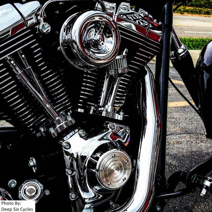 A disassembled TC Bros. Chrome Louvered Air Cleaner for HD CV Carbs & EFI with a chrome cover, red filter element, black mounting base, and hardware including screws and bolts—perfect for Harley Davidson Big Twin and Sportster models.