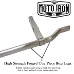 Two Moto Iron® Springer Front Ends for Harley-Davidson frames with 1" necks—one chrome, one black—are displayed side by side with a metal rod and two small parts. Ideal for custom Harley-Davidson springer setups.