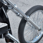 A close up view of a Biker's Choice 39mm Chrome Fork Boots and Seals for Sportster Models wheel and tire with chrome-plated dust shields.