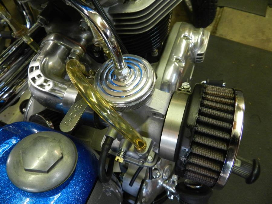 Close up of an upgraded LC Fabrications Mikuni Aluminum Top VM30-VM34 motorcycle engine with a polished aluminum finish and Mikuni VM series carbs.