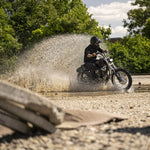 The TC Bros. Scrambler LED Headlight Kit for Harley-Davidson includes two black LED light bars with wiring, connectors, brackets, and hardware—perfect for off-road use or upgrading your Harley's lighting system.