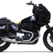 A black motorcycle with a yellow seat equipped with the Two Brothers 2 into 1 Stainless Exhaust System For Harley Sportster Models 1983-2003, made by Two Brothers.