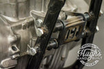 A set of Hughs HandBuilt XS650 Motor Mount Kit (74-Up) bolts, nuts, and washers for a motorcycle chassis.