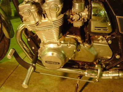 A close up of the engine of a TC Bros. Honda DOHC CB750 Forward Controls Kit motorcycle.