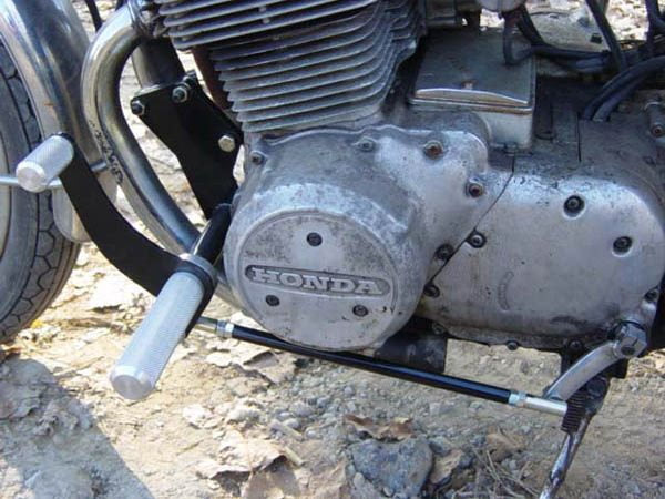 A close up of the TC Bros. Honda SOHC CB750 Forward Controls Kit engine, showcasing its bolt-on forward controls.