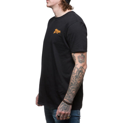 A man wearing a TC Bros. Classic T-Shirt - Black made of 100% ring-spun cotton.