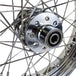 A close up of a Mid-USA chrome rear 40 spoke wheel 16"x3", adhering to OEM specs on a Harley Ironhead Sportster XL from 1955-1978.