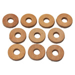 A stack of TC Bros. Leather Cushion Washers—round, flat, brown leather washers with a center hole for motorcycle vibration dampening—by TC Bros., displayed on a white background.