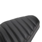 A close up of a TC Bros. Hardtail Rigid Mount Solo Seat Black Pleated motorcycle seat with horizontal pleated stitching style.