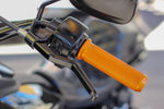 Close-up of a motorcycle handlebar with an orange rubber grip, rearview mirror, and the 1FNGR Easier Pull Clutch Lever Assembly for 1982-2024 Harley-Davidson, designed for smoother clutch operation.