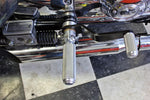 The TC Bros. Mid Controls Kit for 1991-2003 Harley-Davidson Sportster features metal foot pegs and a gear shift lever, perfect for upgrading your bike. Components are arranged on a white background.