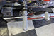The TC Bros. Mid Controls Kit for 1991-2003 Harley-Davidson Sportster features metal foot pegs and a gear shift lever, perfect for upgrading your bike. Components are arranged on a white background.