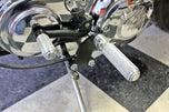 The TC Bros. Mid Controls Kit for 1991-2003 Harley-Davidson Sportster features metal foot pegs and a gear shift lever, perfect for upgrading your bike. Components are arranged on a white background.