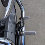 The TC Bros. Mid Controls Kit for 2004-2013 Harley-Davidson Sportster includes black brackets, silver foot pegs, bolts, nuts, washers, and a linkage rod from TC Bros., all arranged on a white background.