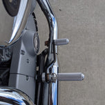 The TC Bros. Mid Controls Kit for 2004-2013 Harley-Davidson Sportster includes black brackets, silver foot pegs, bolts, nuts, washers, and a linkage rod from TC Bros., all arranged on a white background.